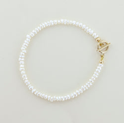 Sailormade women's minimalist fresh water white pearl bracelet with 14k gold fill clasp. Handmade in Newburyport, MA.