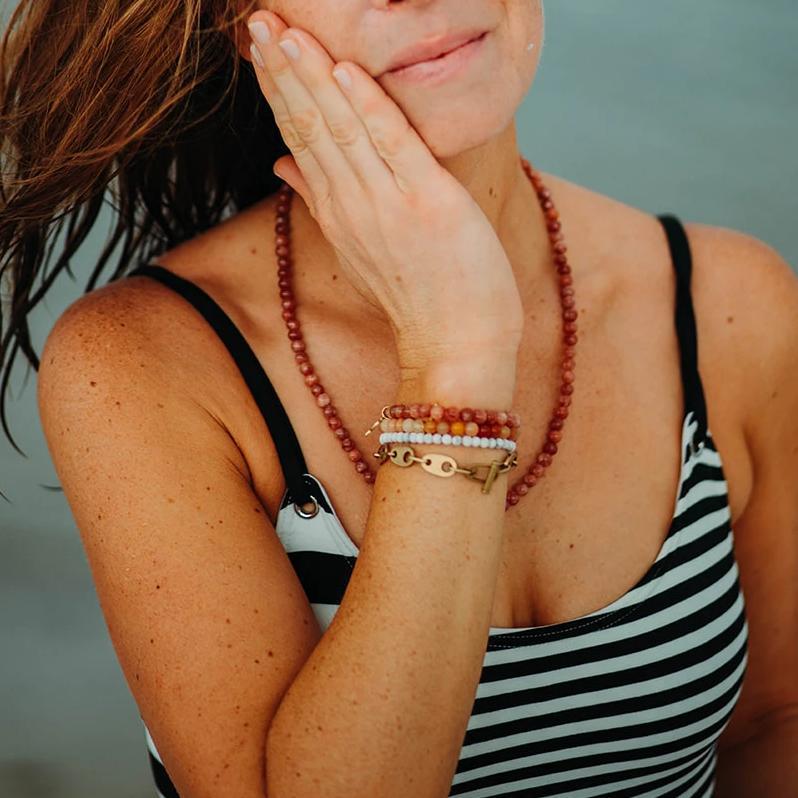 UV awareness beaded beach bracelet for sun safety in howlite, sunstone, topaz jade, with link chain bracelet in brass, rayminder beaded necklace in sunstone