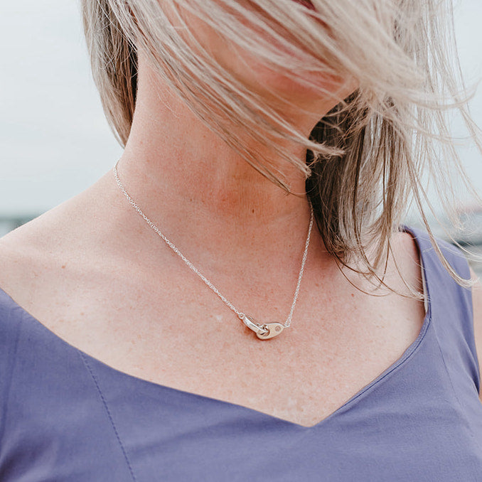 Woman on New England coast wearing classic sailormade nautical double brummel necklace in sterling silver. Plum Island, Newburyport, MA.