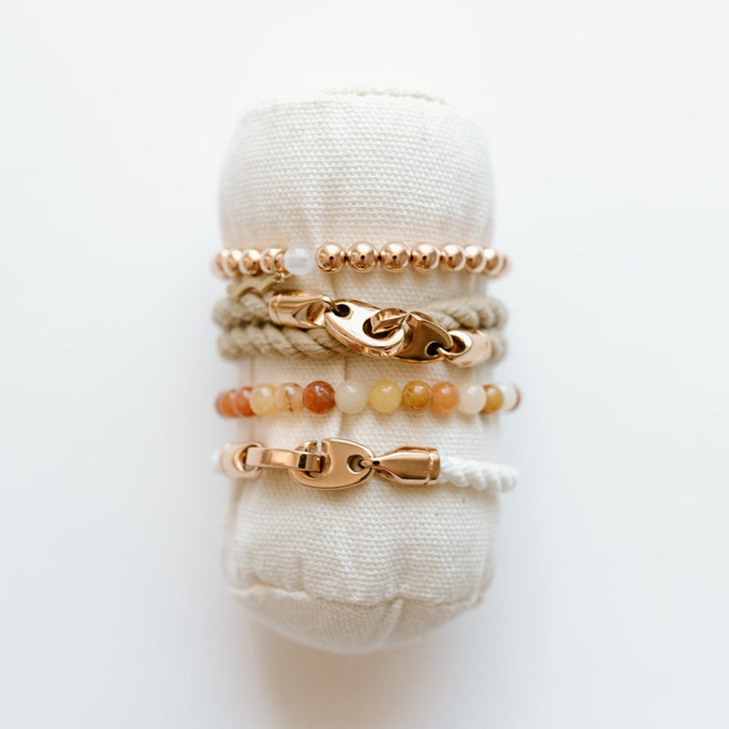 Sailormade women’s nautical double wrap marine rope bracelet with rose gold brummel clasps in wheat with single wrap rope in white and rayminder uv awareness bracelets in 14k rose gold and topaz jade. Handmade in Boston, MA. 