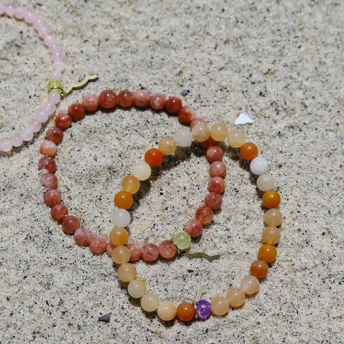 Sailormade rayminder uv awareness bracelets for sun safety. Topaz Jade, sunstone, rose quartz. Made in Boston, MA.