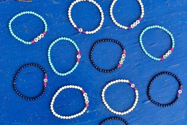 ustom Letter Bead Rayminder UV Awareness bracelets for sun safety and uv protection in howlite, lapis lazuli, cyan turquoise