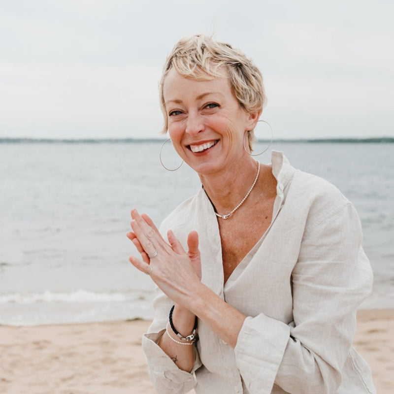 Woman on Plum Island wearing Sailormade nautical single wrap rope brummel bracelet in navy paired with pearl mini brummel bracelet. New England style with accessories handmade in Boston, MA.