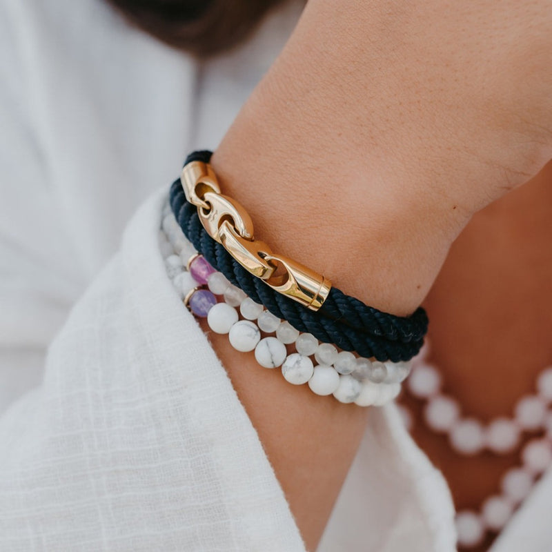 Sailormade women’s nautical double wrap marine rope bracelet with rose gold brummel clasps in navy and Rayminder UV Awareness bracelets in moonstone and howlite. Handmade in Boston, MA.