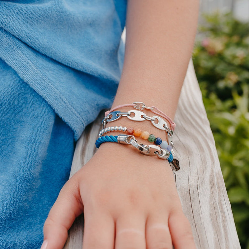 Sailormade Women's nautical bracelet stack with brummel link chain in polished silver chrome, mini sterling silver brummel bracelet, uv awareness bracelet, and ocean blue rope.