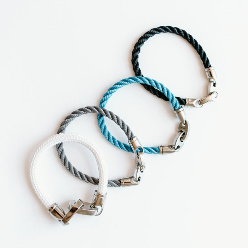 Stack of Sailormade single wrap rope brummel bracelets with stainless steel clasp in charcoal gray, ocean blue, and navy. Made in Boston, MA.