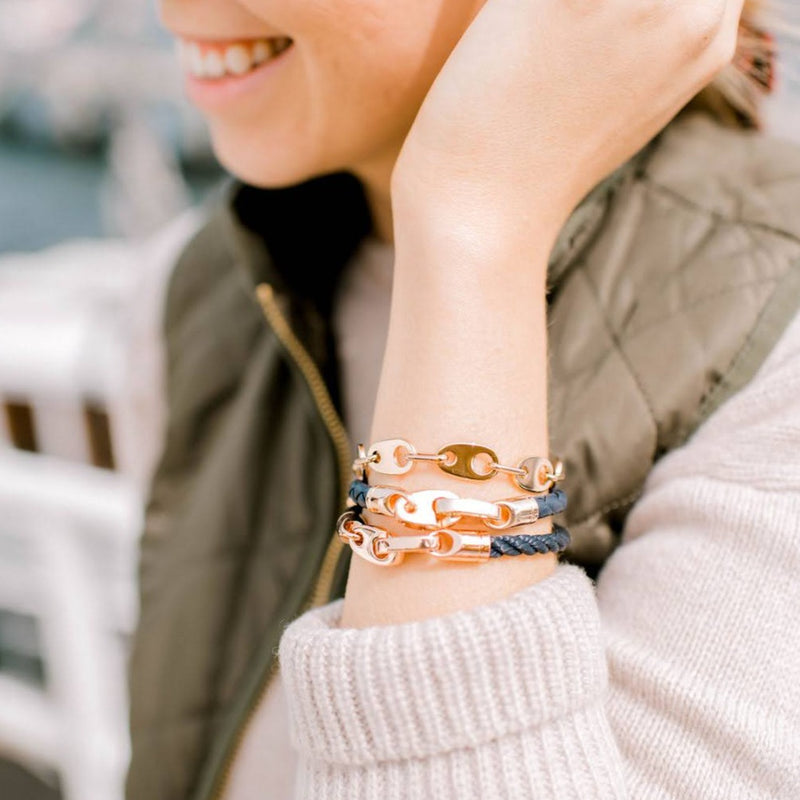 Nautical women’s bracelets are stacked with rose gold brummels in navy rope and leather wraps, paired with preppy chain link bracelets. Handmade in our Boston, MA jewelry studio.