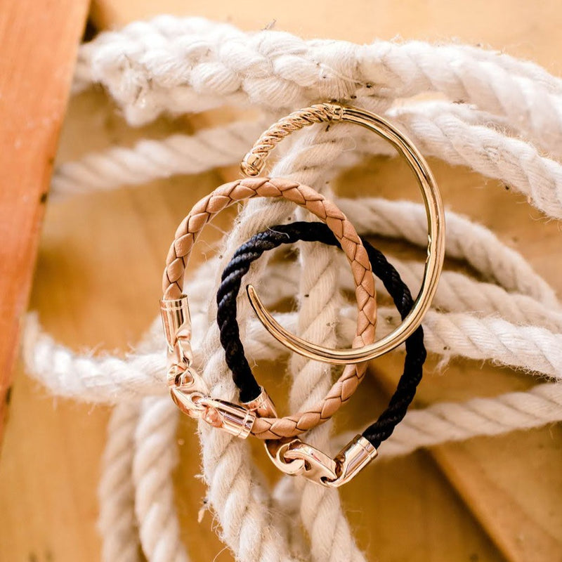 Sailormade women’s nautical single wrap leather bracelet with rose gold brummel clasps in baked brown, single wrap rope bracelet in navy, and slim fid cuff bracelet. Handmade in Boston, MA. 
