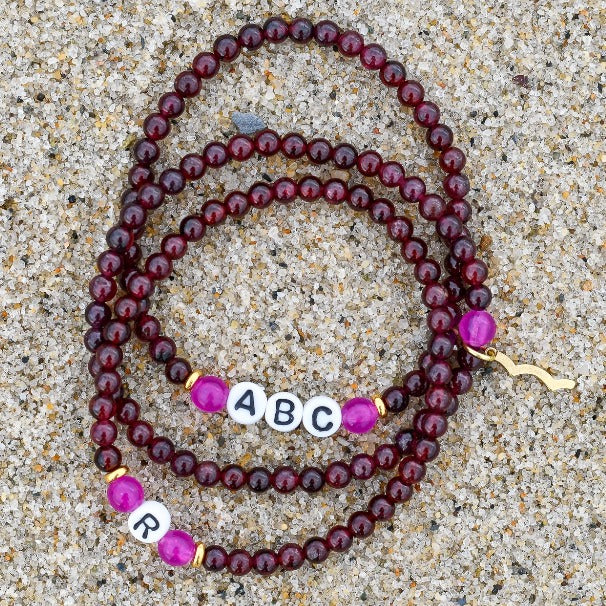 Stackable Rayminder UV Awareness bracelets for sun safety and uv protection in garnet