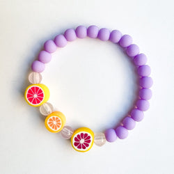 Sailormade kid's rayminder uv awareness bracelet for sun safety education with citrus beads in purple. Handmade locally in Boston.