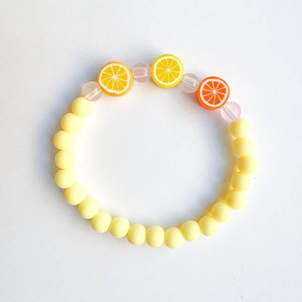 Sailormade kid's rayminder uv awareness bracelet for sun safety education with citrus beads in yellow. Handmade locally in Boston.