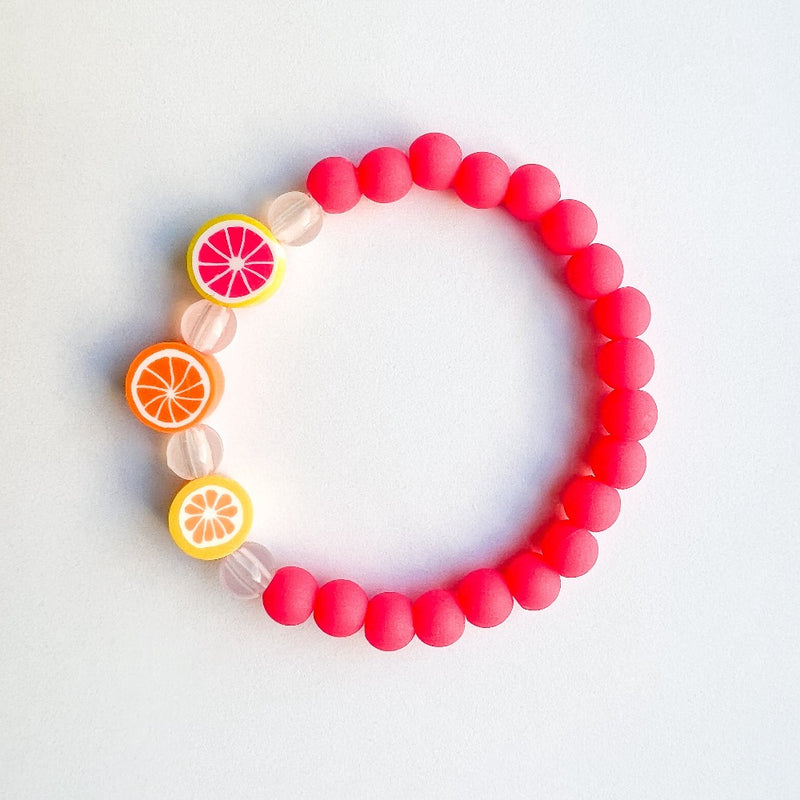 Sailormade kid's rayminder uv awareness bracelet for sun safety education with citrus beads in hot pink. Handmade locally in Boston.