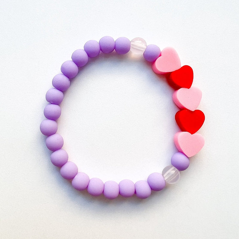 Sailormade kid's rayminder uv awareness bracelet for sun safety education with heart beads in purple, pink, and red. Handmade locally in Boston.