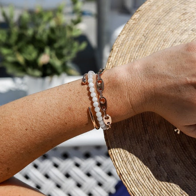 Sailormade women’s nautical slim fid cuff stacking bracelet in rose gold with nautical brummel link chain bracelet and rayminder uv awareness bracelet in moonstone