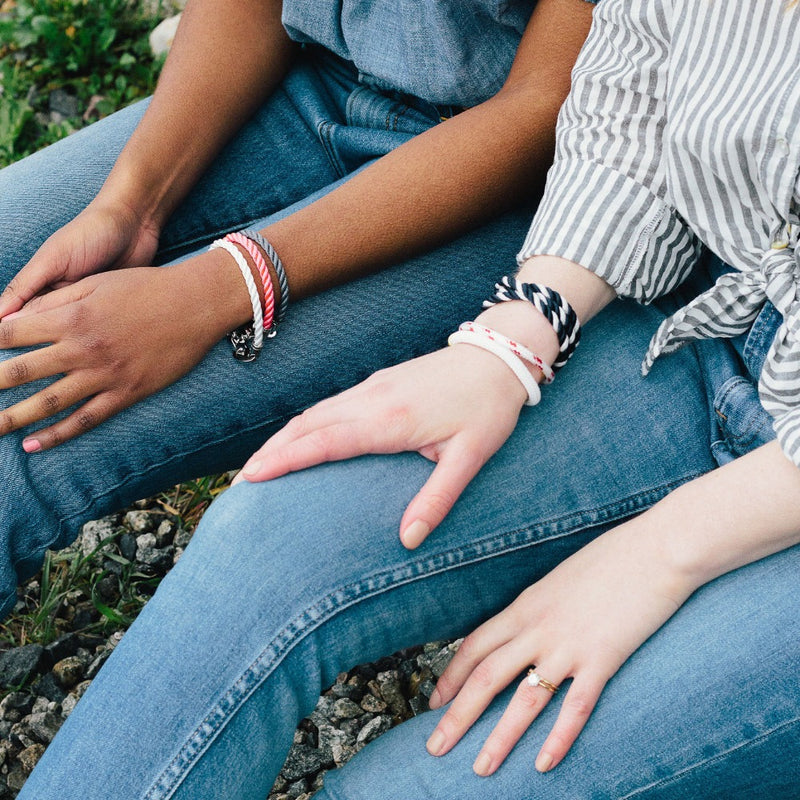 Women in Rockport wearing Sailormade preppy bracelet stacks; elsewhere single wrap rope bracelet in white, pink, and charcoal.