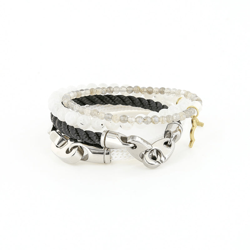 Sailormade women's Charter Big Brummel Bracelet in stainless steel and white, Elsewhere Single Wrap Rope Bracelet in Black,  Rayminder UV Awareness Bracelet in 6MM Moonstone,  and Rayminder UV Awareness Bracelet in 4MM Labradorite.