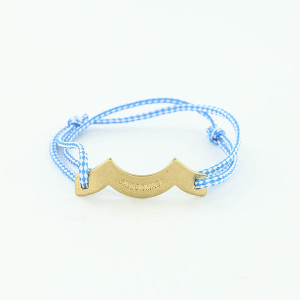 Sporting slip knot rope bracelet with brass wave charm in blue + white. Made in Boston.