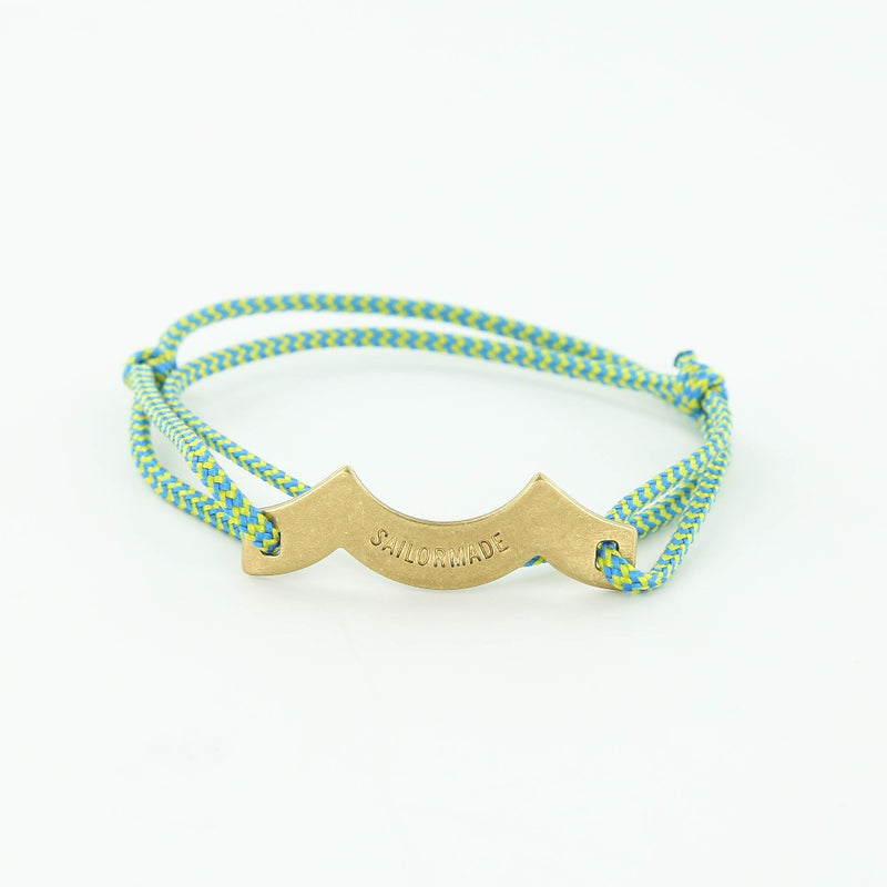 Sporting slip knot rope bracelet with brass wave charm in blue + green. Made in Boston.