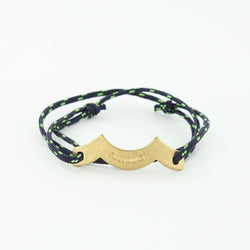 Sporting slip knot rope bracelet with brass wave charm in navy and neon green. Made in Boston.